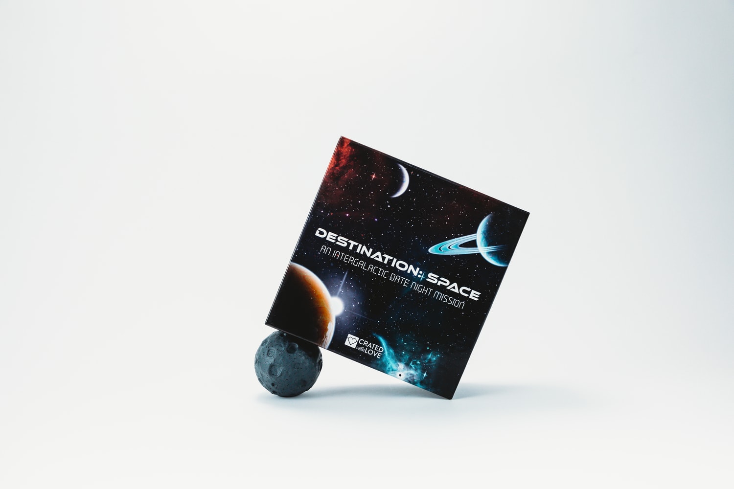 Destination: Space date box tilted on the side on asteroid stress ball